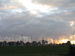 SX24446 Sunsetting behind clouds and masts in marina Brouwershaven.jpg